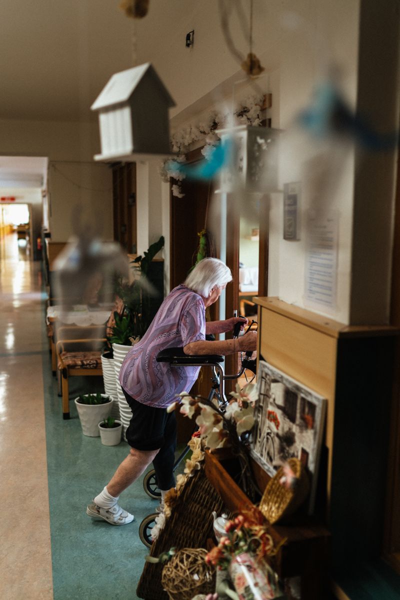 Senior in assisted living community hallway