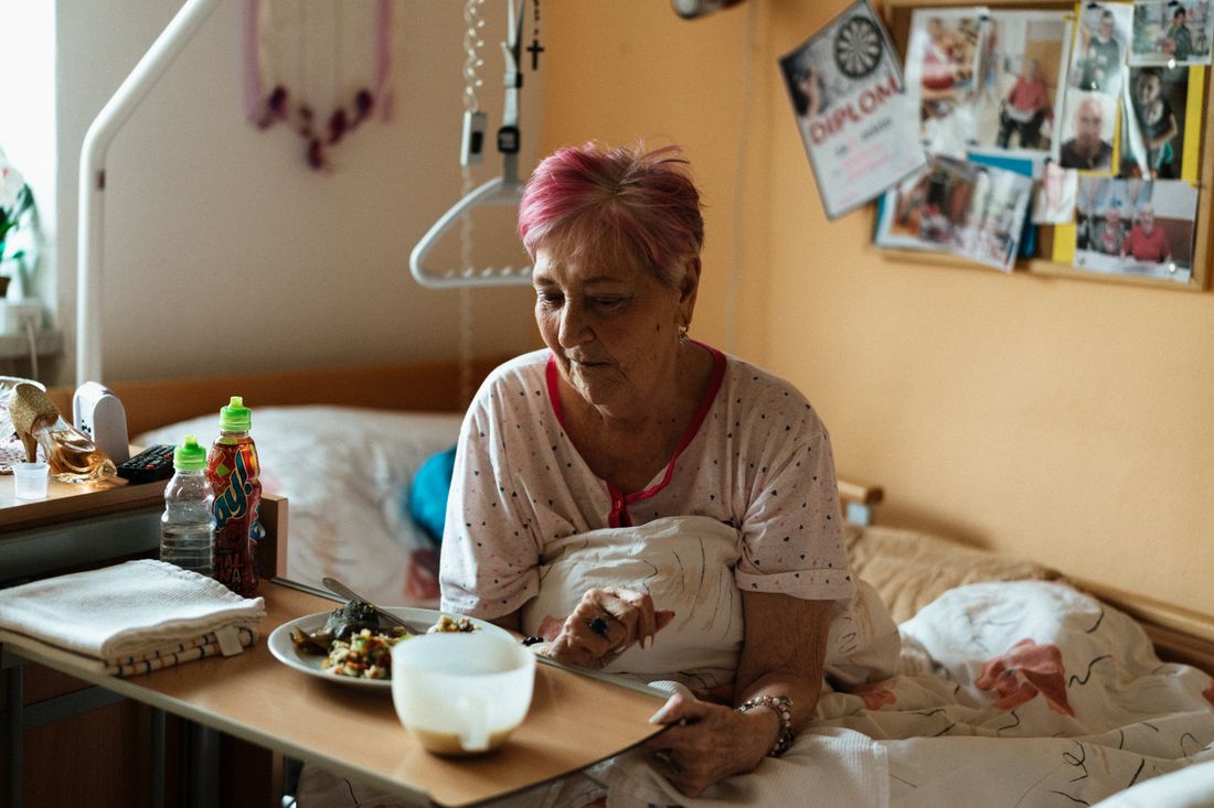 A resident having a meal in their room at a care home