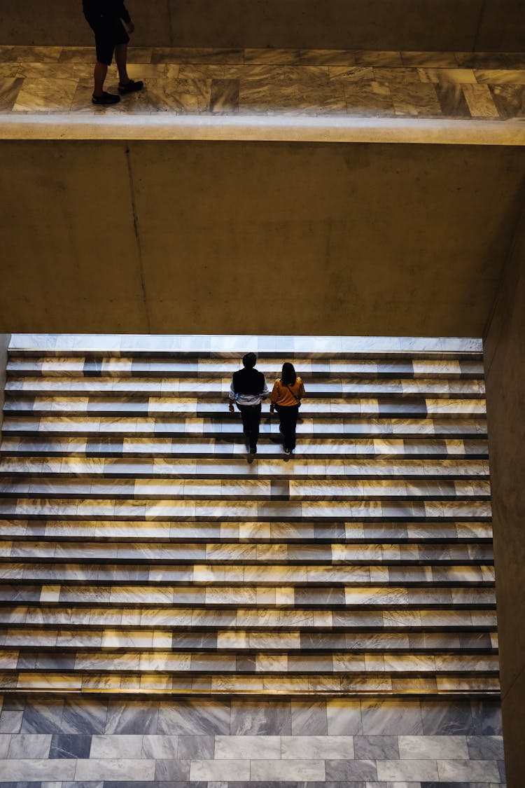 Couple Walking Together On Stairs