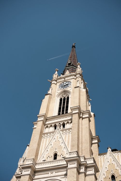 Free A striking view of the Name of Mary Church tower in Novi Sad against a blue sky. Stock Photo