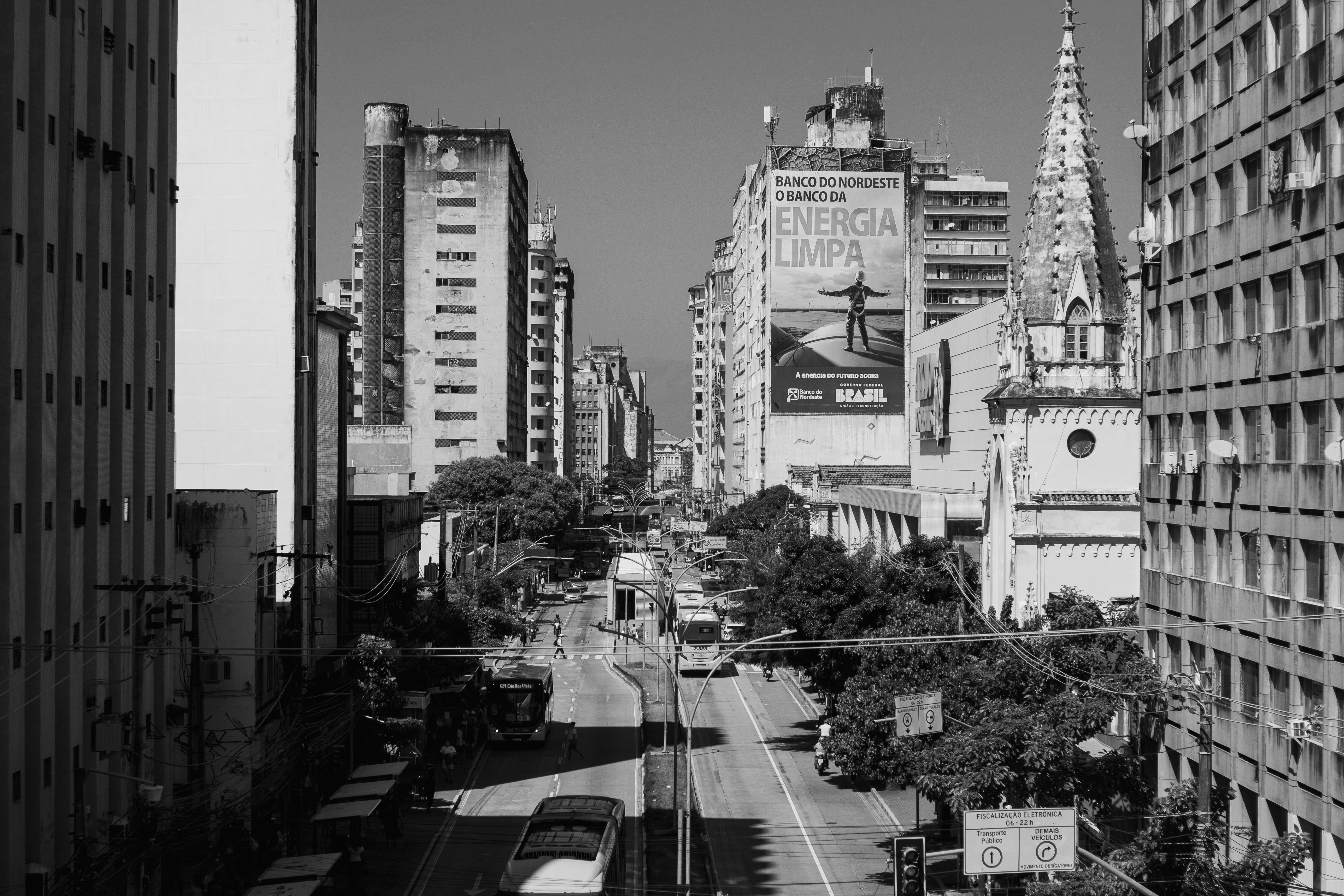 A black and white street view of Recife, showcasing its urban cityscape with buildings and traffic.