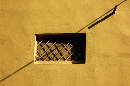 Sunlit Wall with Bars on Window