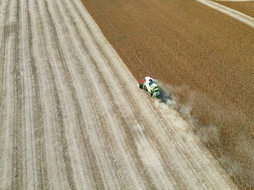 Free Drone Shot of a Combine Harvester on a Cropland  Stock Photo