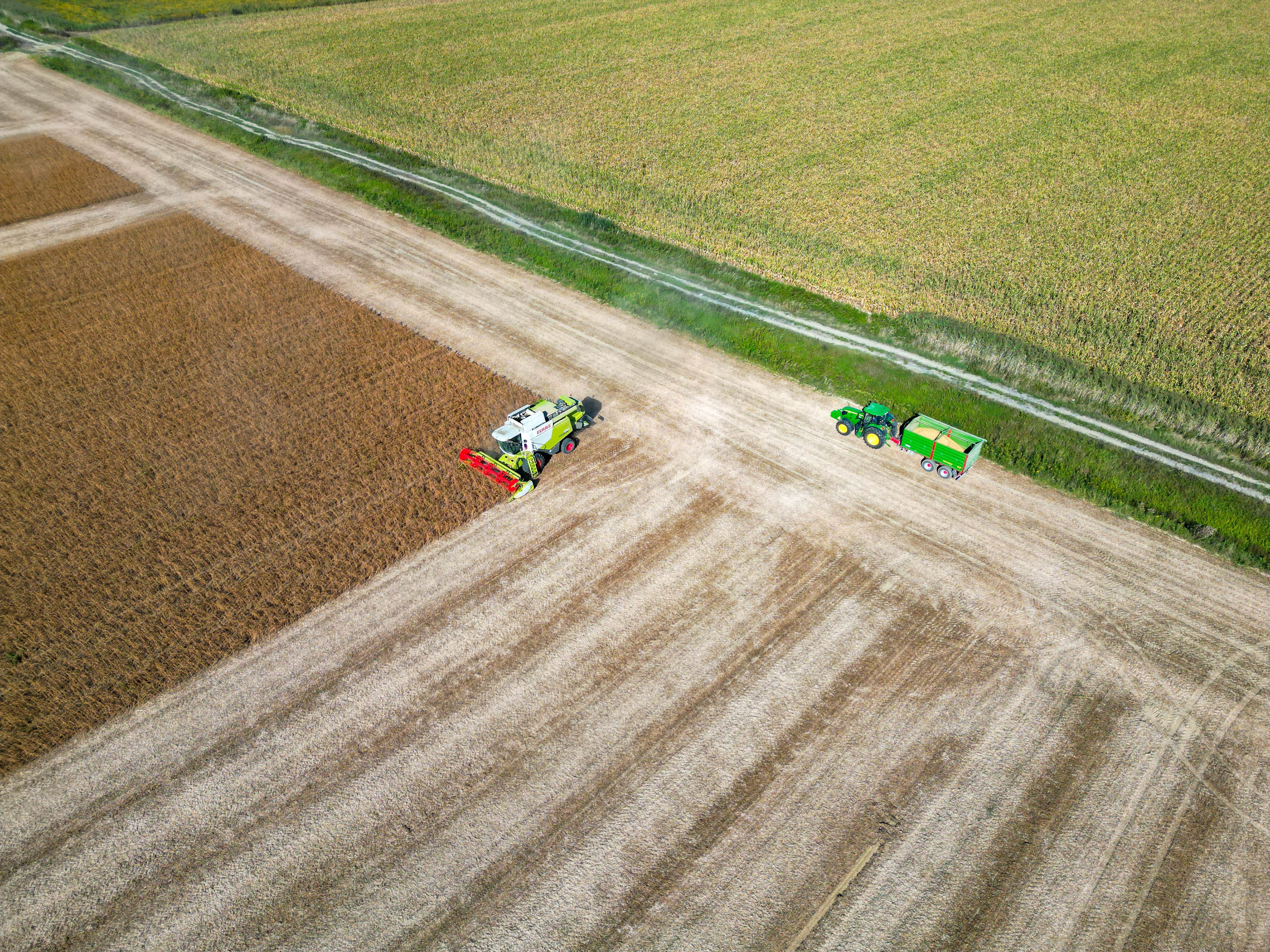 Aerial View of a Combine Harvester and a Tractor on a Crop · Free Stock ...