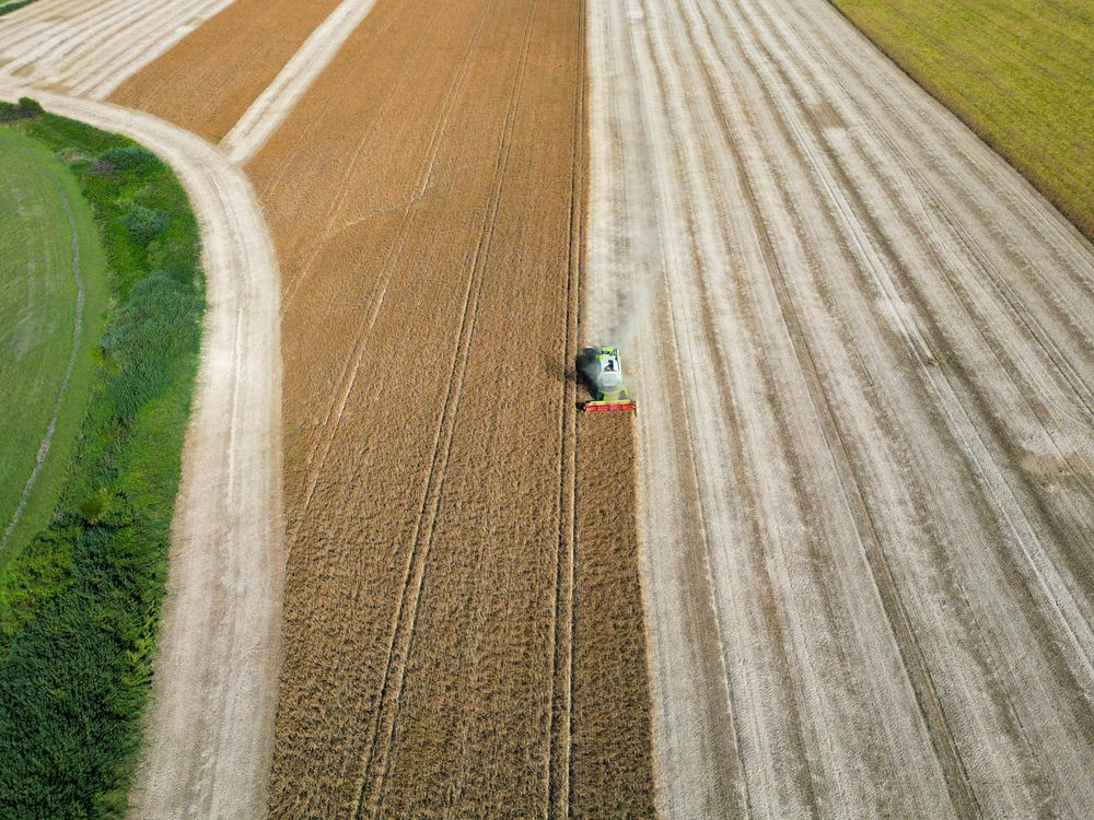 Drone Shot of a Combine Harvester on a Cropland · Free Stock Photo