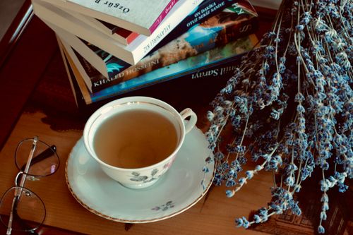 Free A serene setup with tea, books, and dried lavender on a wooden table, perfect for relaxation. Stock Photo