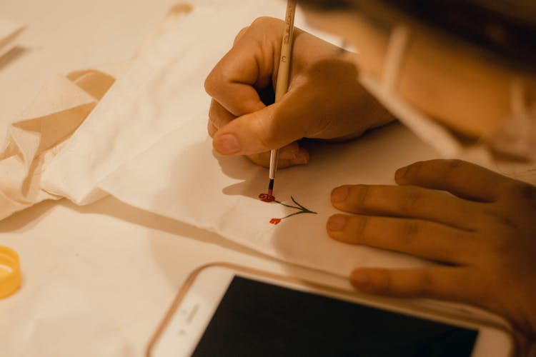 Artist Painting Flowers On Paper Sheet