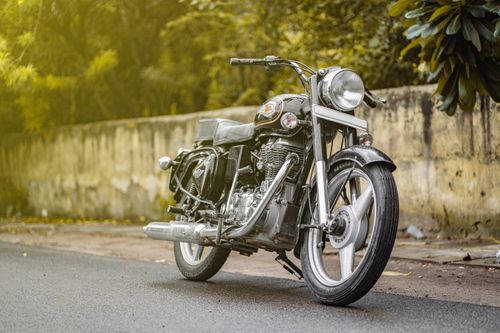Free A vintage Royal Enfield motorcycle parked on a street in New Delhi, India, showcasing its classic design. Stock Photo