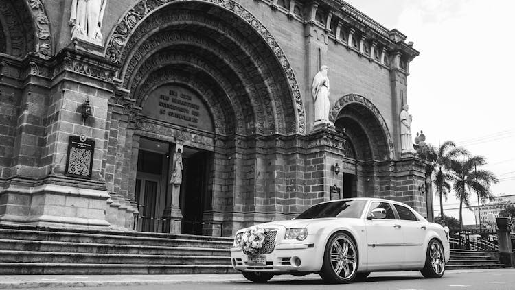 Luxury Car In Front Of A Church In Black And White