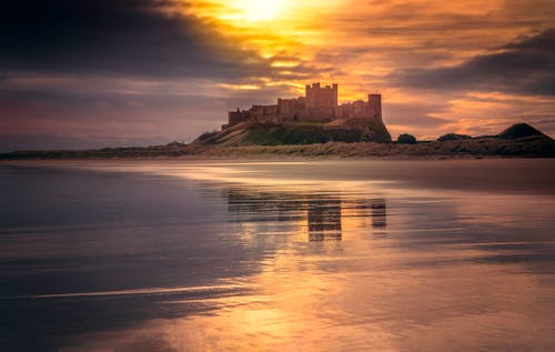 Castle Near Body of Water Under Golden Hour