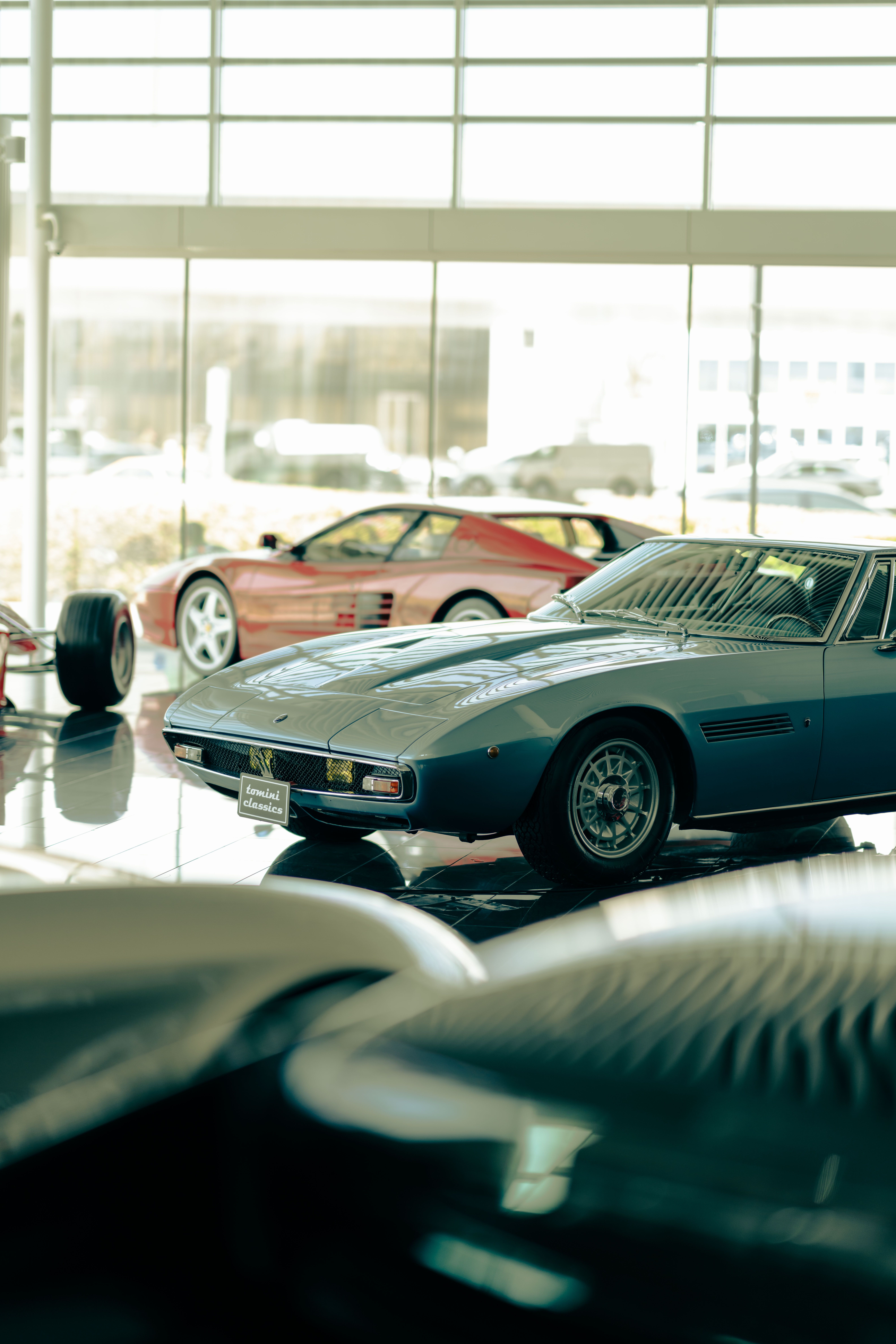 Classic vintage cars showcased in a brightly lit showroom highlighting luxury and elegance.