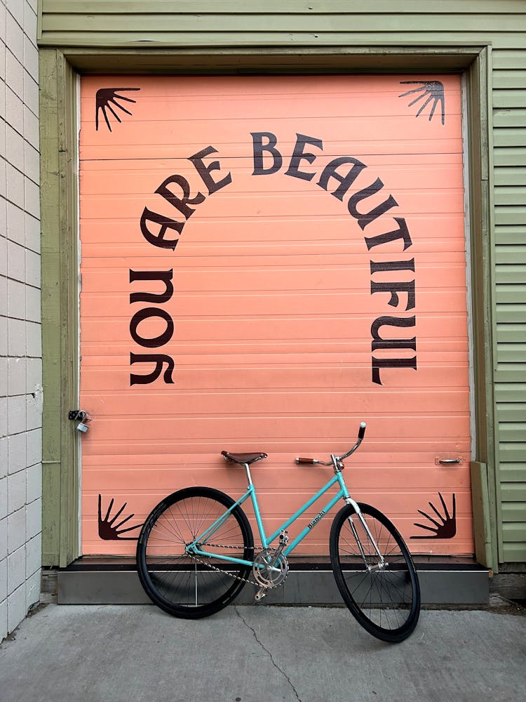 Text On Wall Behind Bicycle