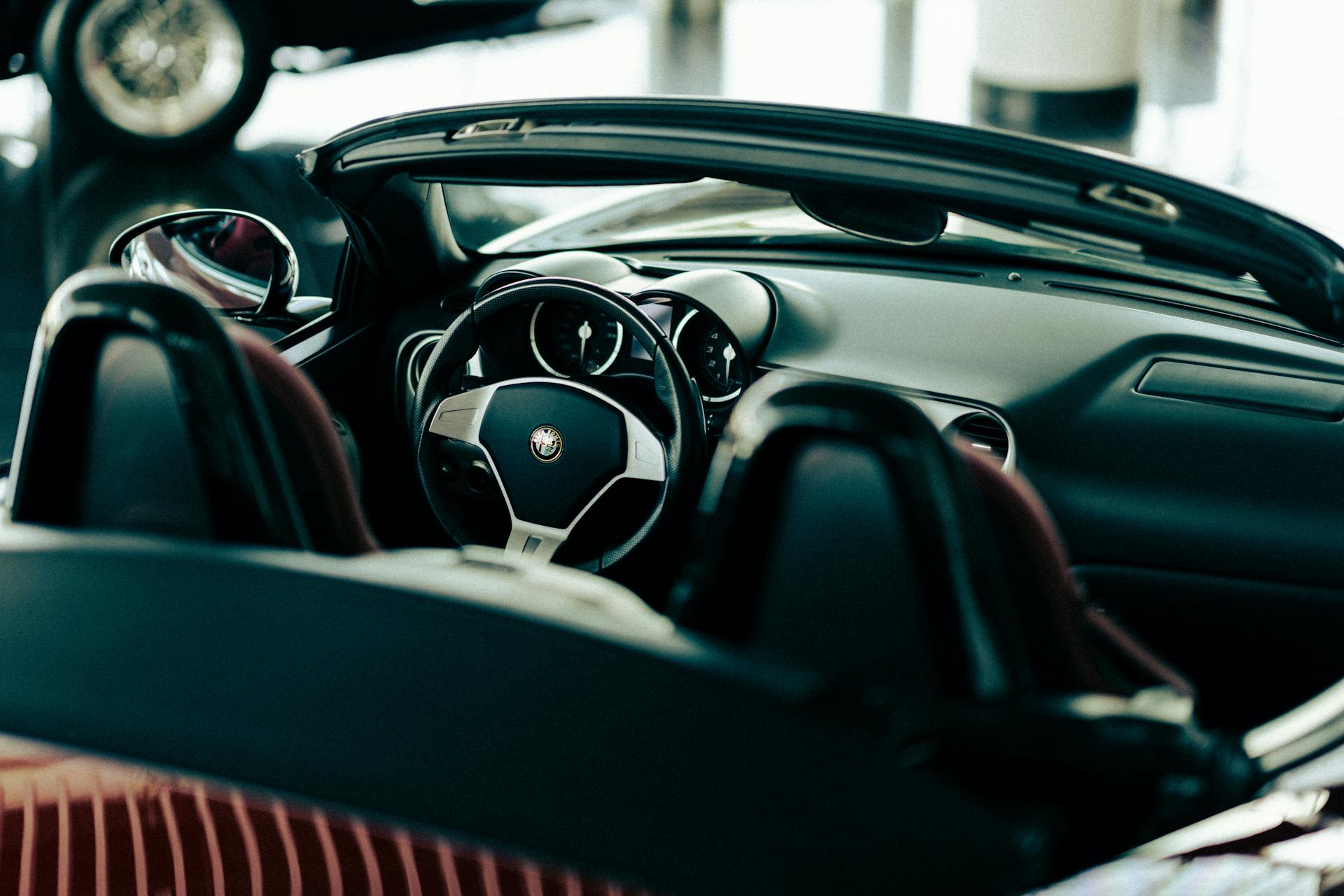 Close-up of a luxury convertible car interior, showcasing sleek design and modern dashboard.