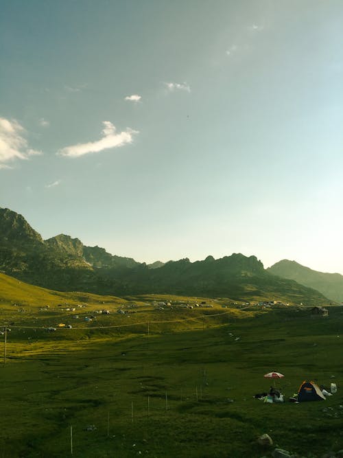 View of Green Fields and Mountains in Summer 