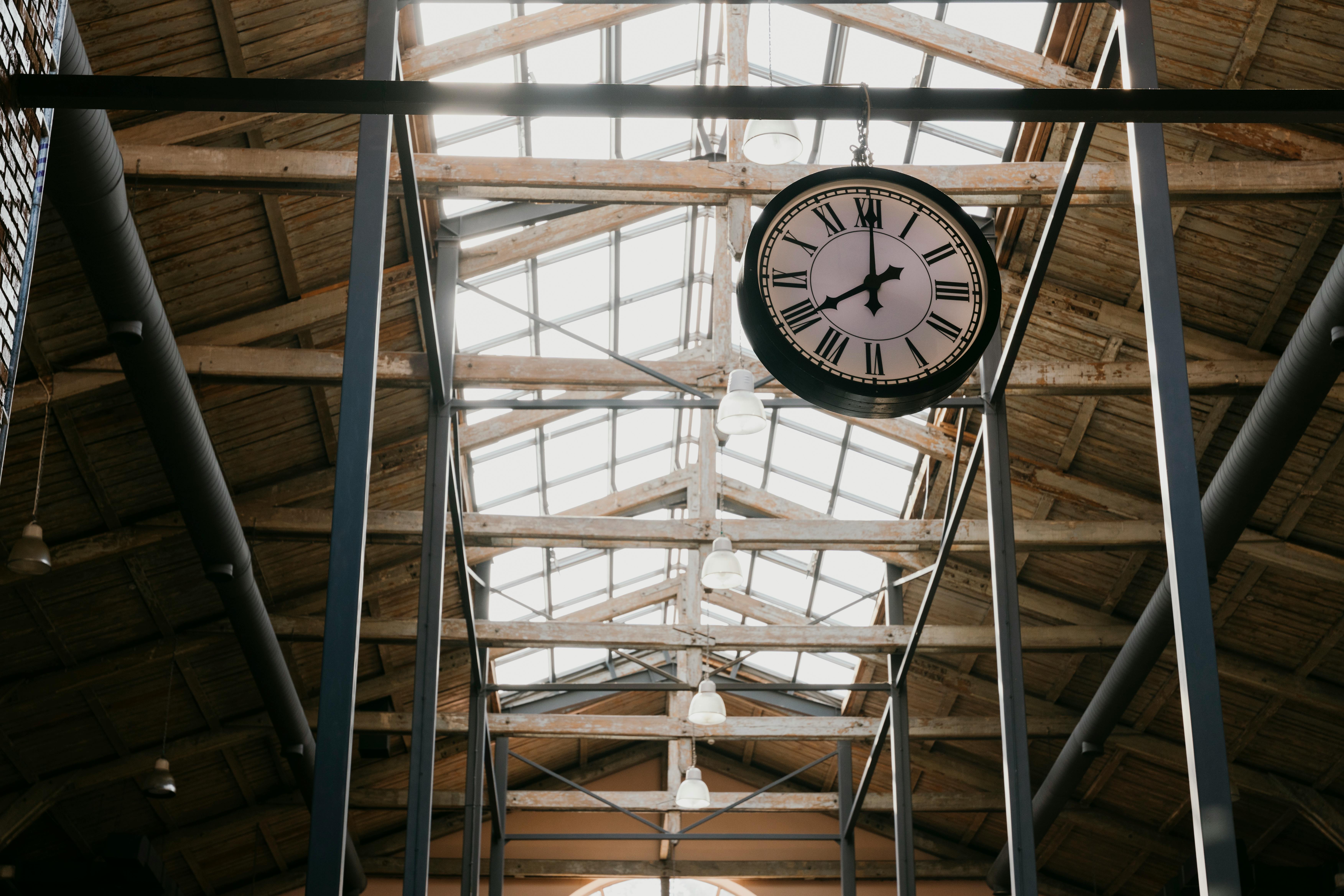 Clock with Roman numerals in an industrial setting, showcasing architectural details in Baku.