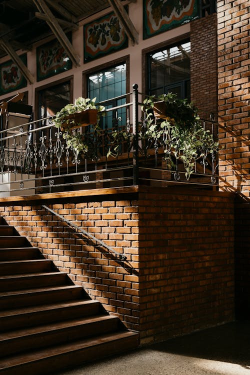 A brick building with stairs and plants