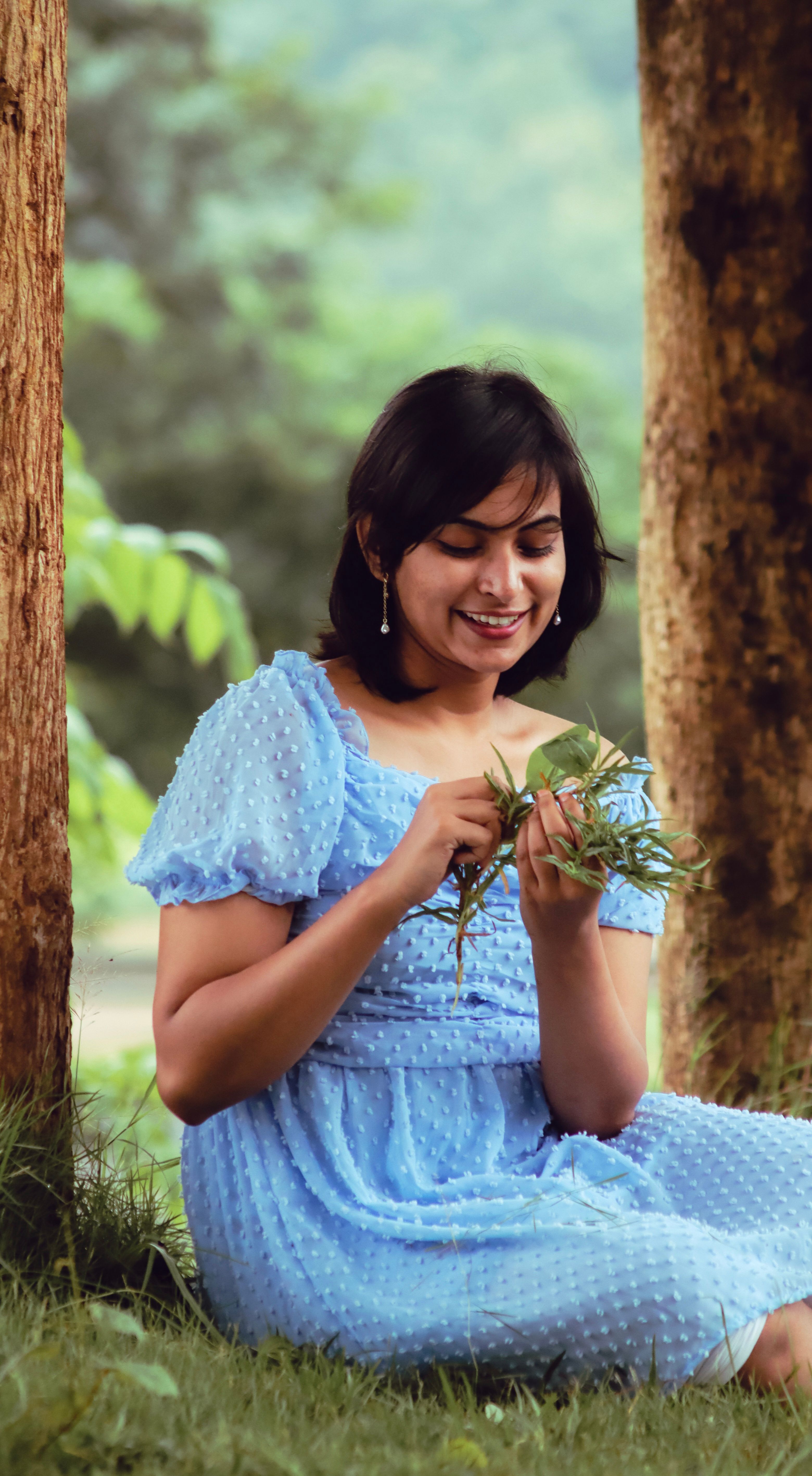 Smiling Woman in Blue Dress Sitting on Grass · Free Stock Photo