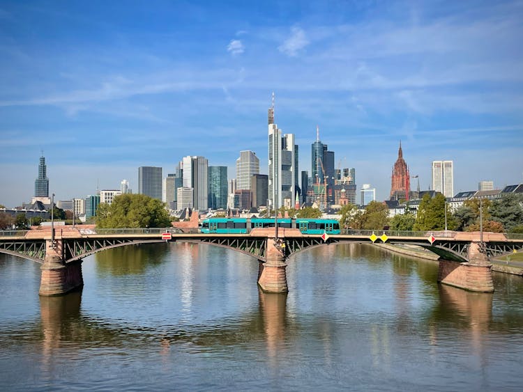 Frankfurt Am Main Panorama With Green Tram Riding On The Ignatz Bubis Bridge