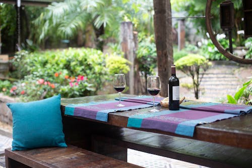 Wine Bottle and Glasses on Purple Mat