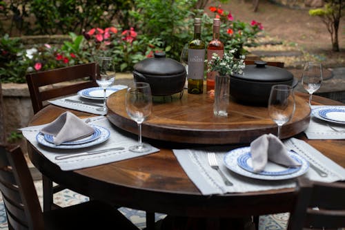 Free Dining Table Set With Plates, Water Goblet and Two Cooking Pots Stock Photo