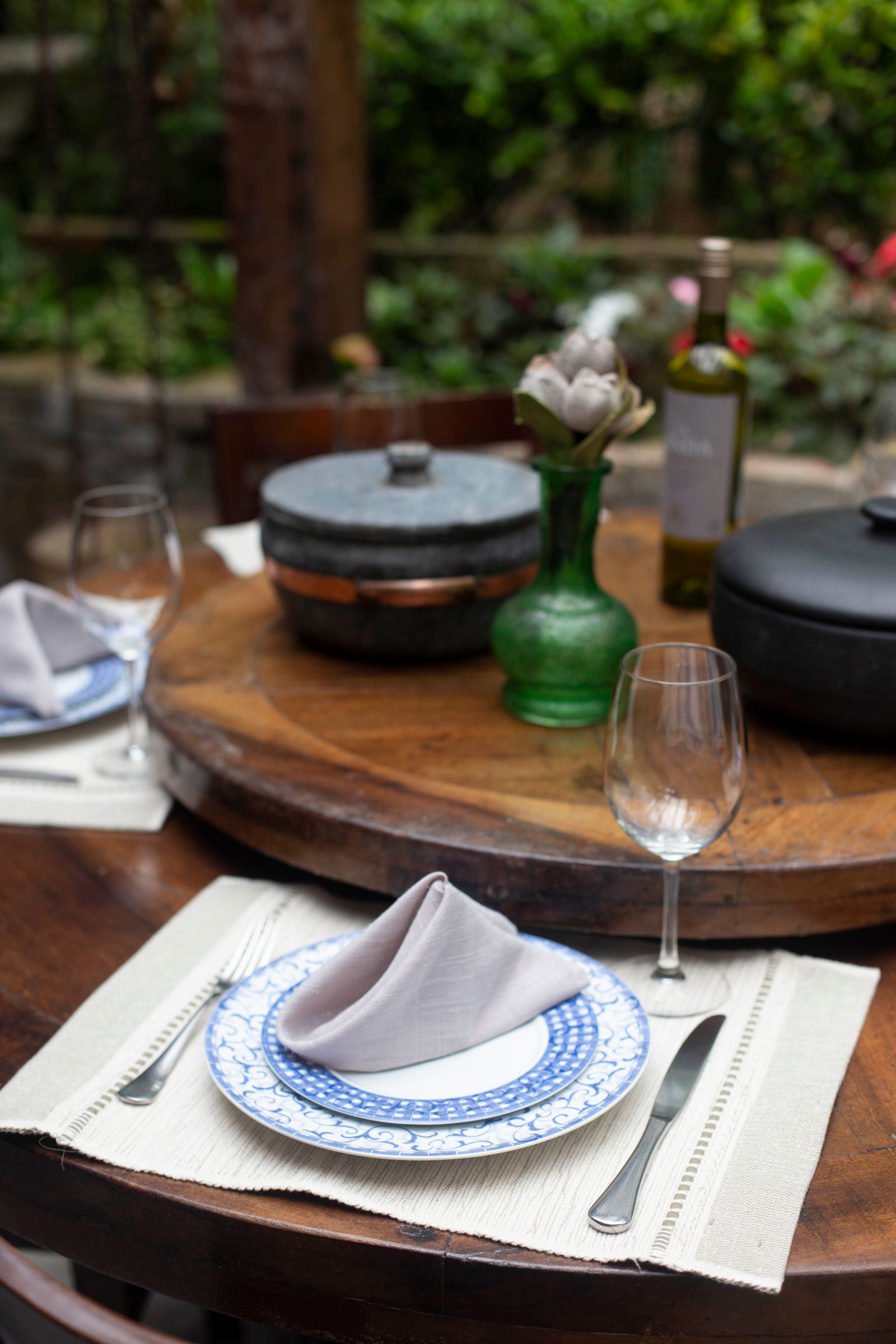 A newly arrived table setting with glassware and warm light