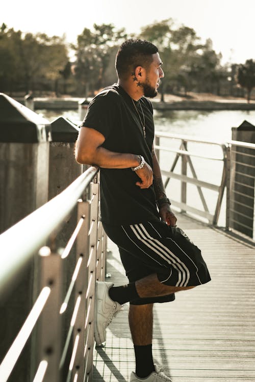 Man in Black T-shirt Standing on Boardwalk