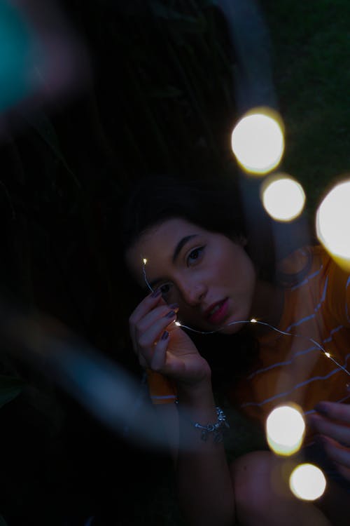 Photo Of Girl Holding String Lights