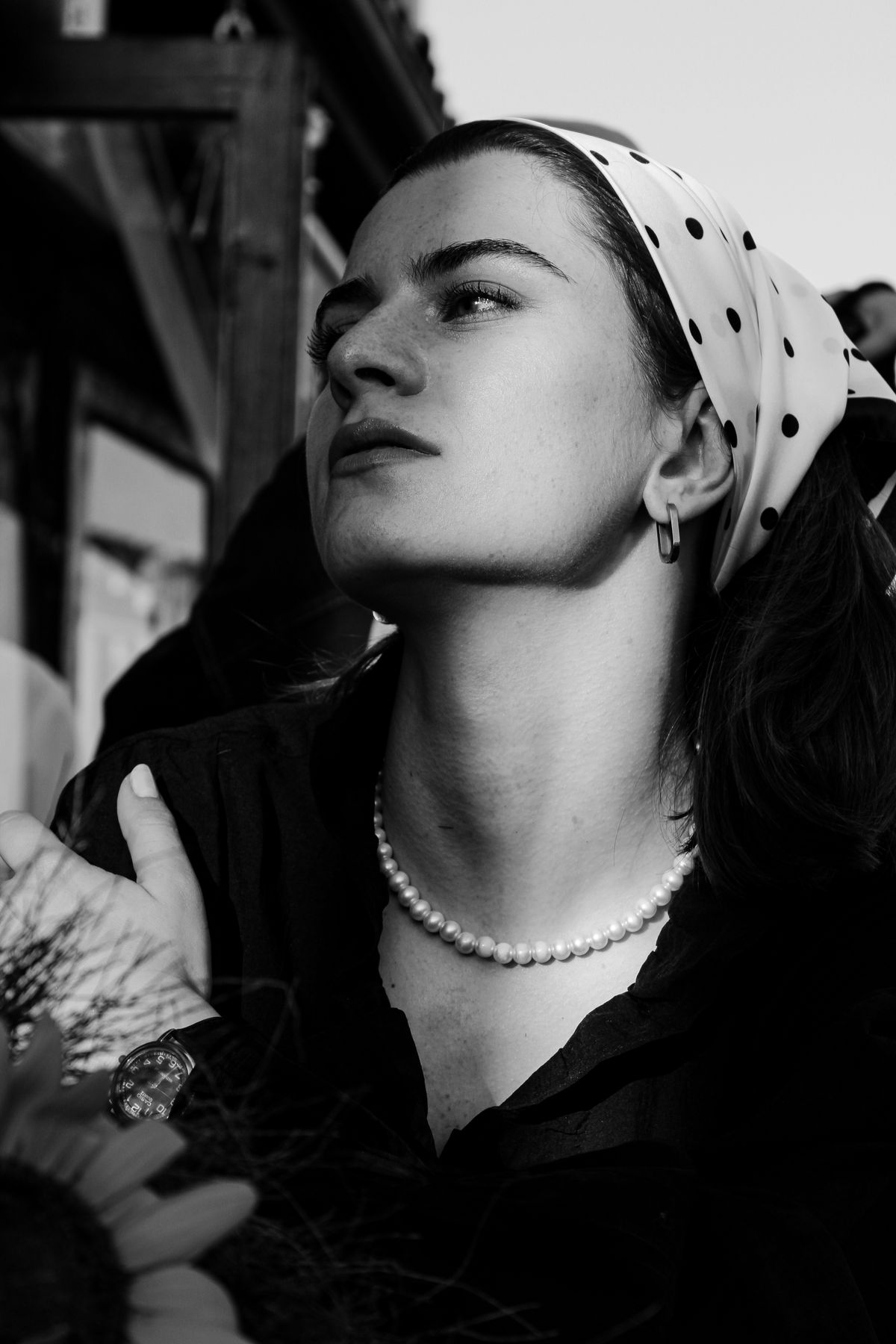 An elegant woman in a printed headscarf