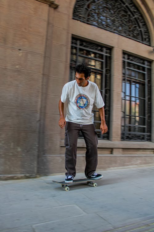 Man in T-shirt Skateboarding
