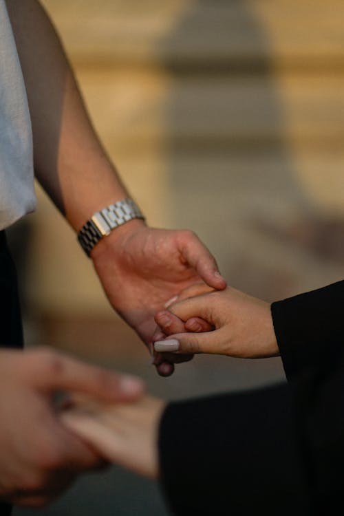Close-up of Man and Woman Holding Hands