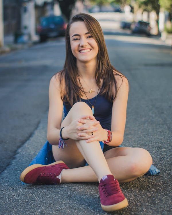 Photo of Woman Sitting on Road