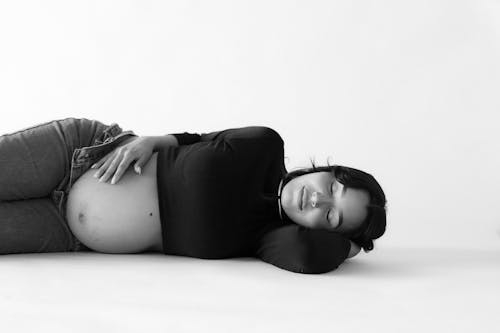 Pregnant Woman Lying Down with Eyes Closed