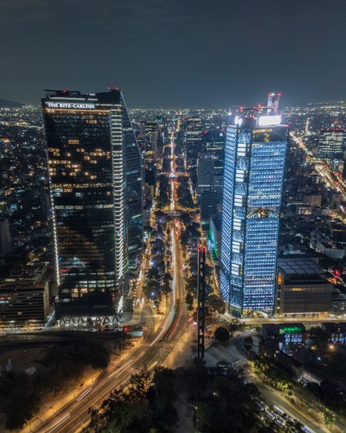 Free Spectacular aerial night view of Ciudad de México with illuminated skyscrapers and bustling cityscape. Stock Photo