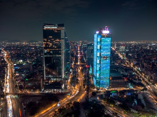 Free Stunning night aerial view of Mexico City's vibrant skyline with illuminated skyscrapers. Stock Photo