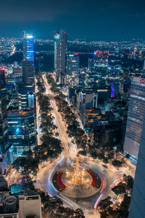 Free Stunning aerial cityscape of Mexico City at night, featuring the Angel of Independence softly illuminated. Stock Photo