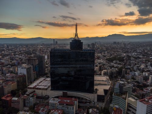 Free Aerial view of Ciudad de México's skyline with a dramatic sunset backdrop. Stock Photo