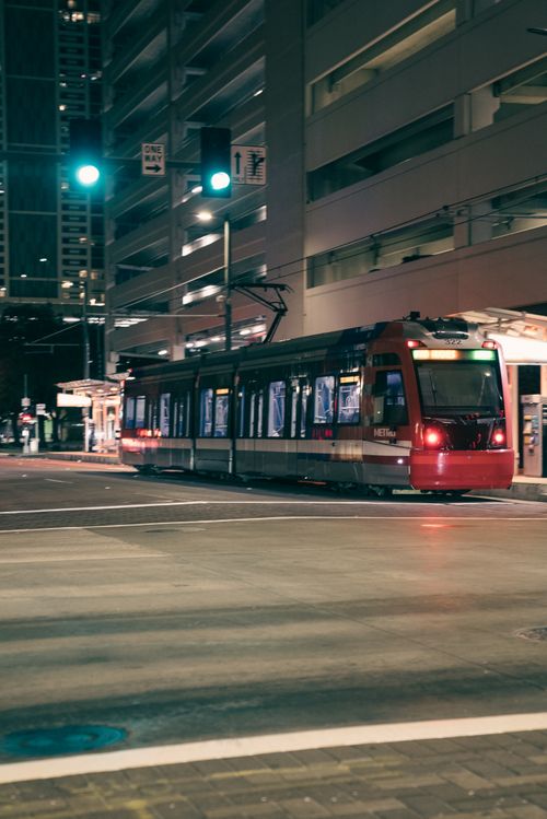 Free A vibrant city scene featuring a tram navigating through city streets at night, capturing urban nightlife. Stock Photo