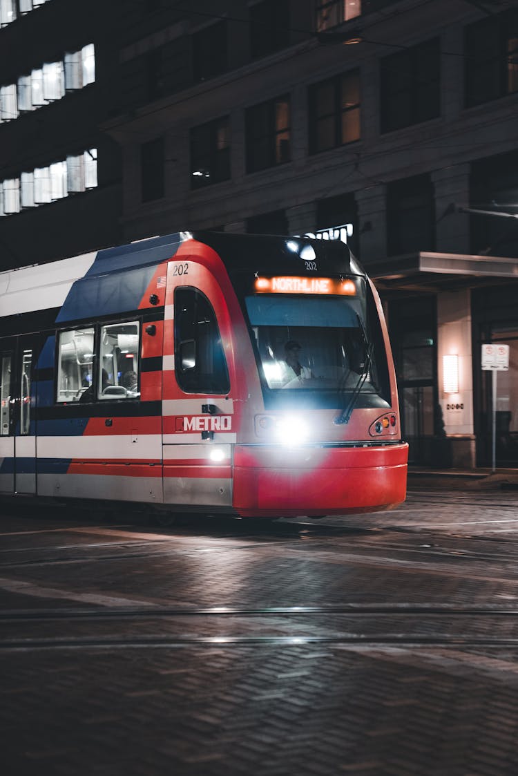 Houston Metro Train Riding On A Night Street