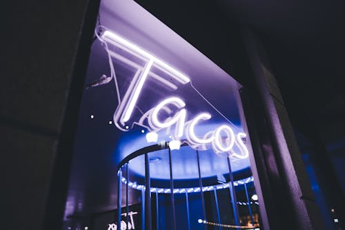 Illuminated Sign on Building Facade at Night
