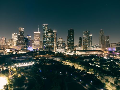 Free Stunning aerial view of the illuminated Houston skyline at night, showcasing urban architecture and vibrant city lights. Stock Photo
