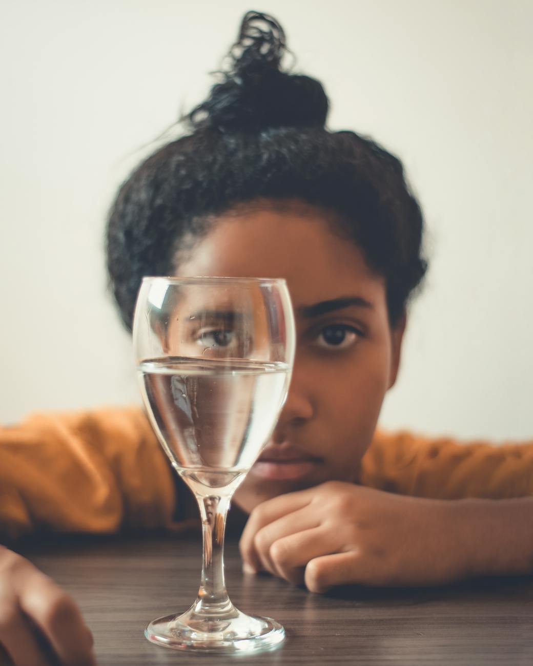 girl looking at glass of water