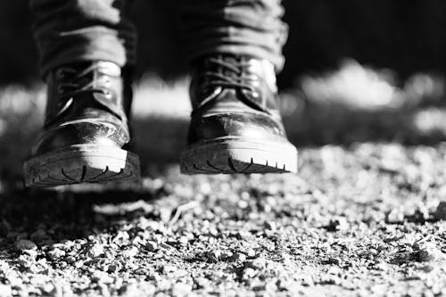 Close-up of Person in Boots on Ground