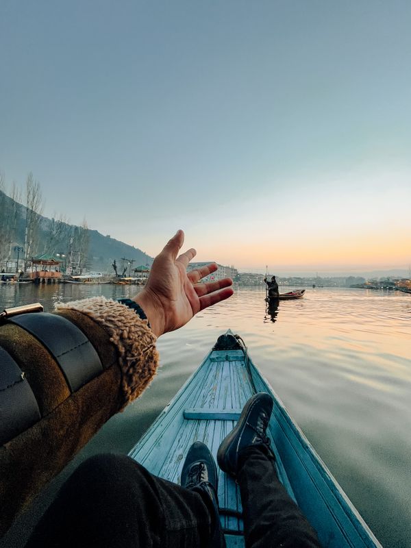 Boy sitting in a shikara on Dal Lake