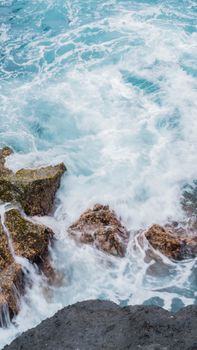 Vibrant ocean waves crash against rocky coast, showcasing nature's energy and beauty. Perfect for seascape lovers.