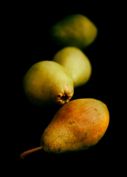 Free A close-up of fresh pears arranged artistically, showcasing vibrant colors against a dark backdrop. Stock Photo