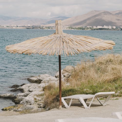 A Beach Umbrella by a Sea