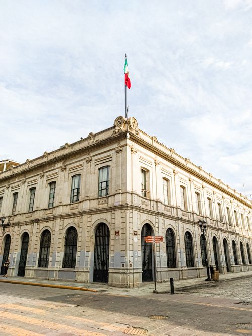 Free Elegant historic building with Mexican flag in Oaxaca City, captured during the day. Stock Photo