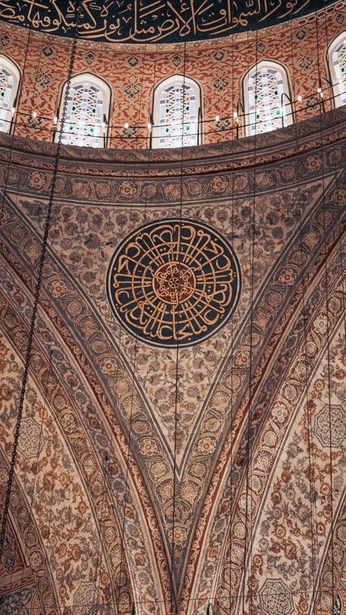 Free Detailed view of ornate ceiling inside an Ottoman mosque in Istanbul, showcasing intricate patterns and calligraphy. Stock Photo