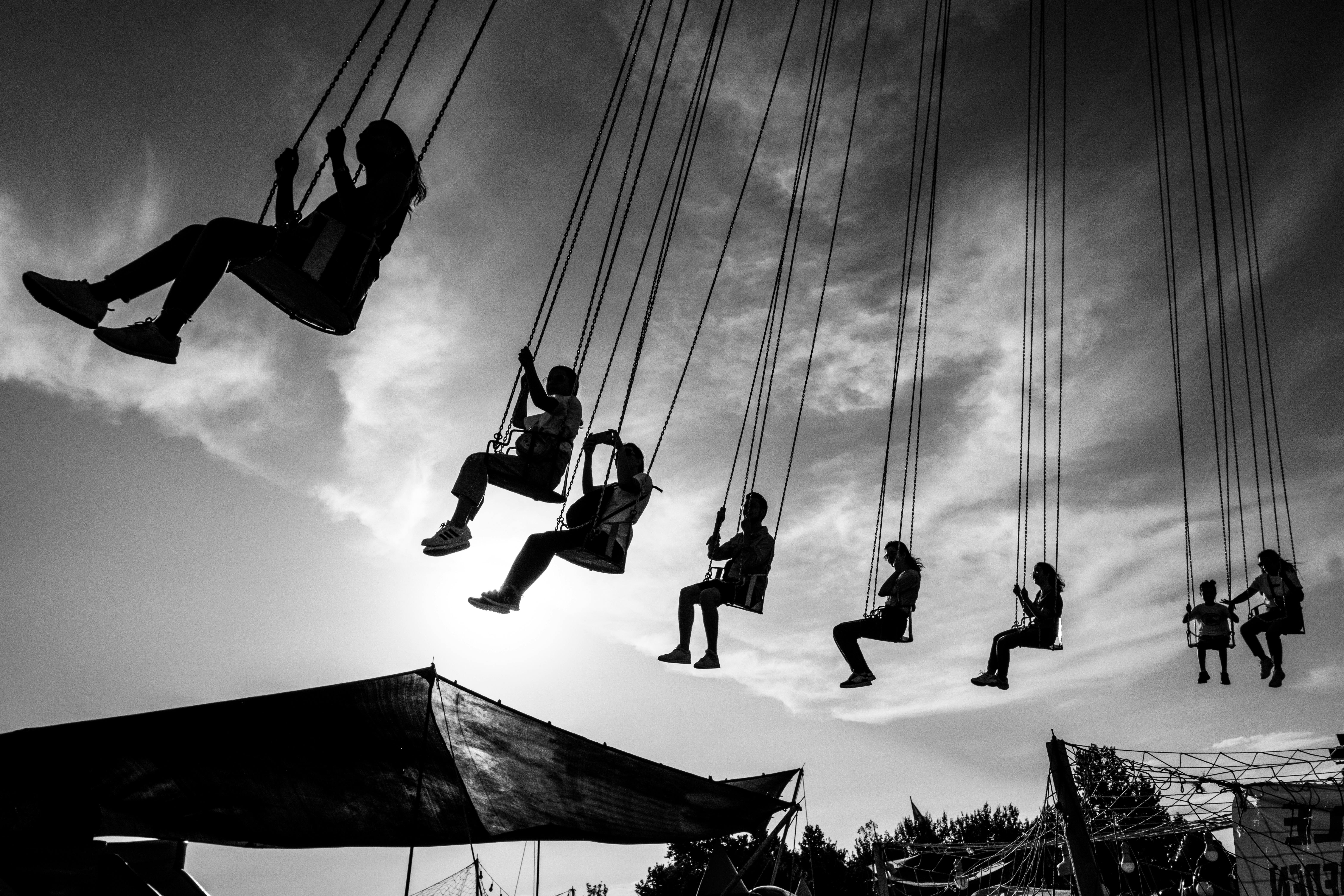 Black and white image of people enjoying a carousel ride at a funfair in Pehlivanköy, Turkey.