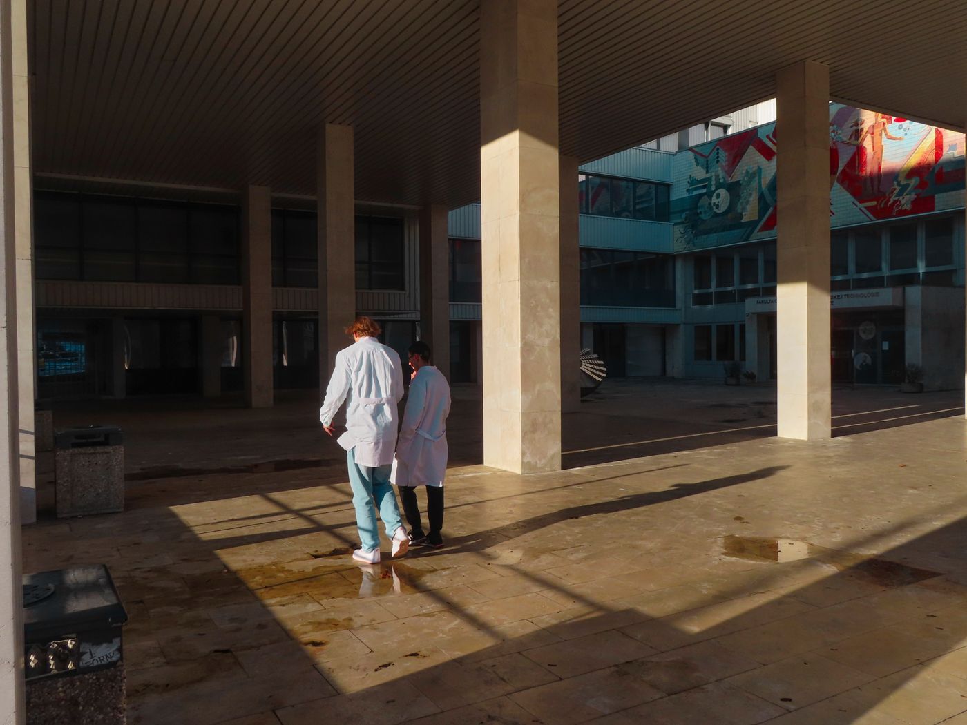 Medical professionals walking outside a modern healthcare facility